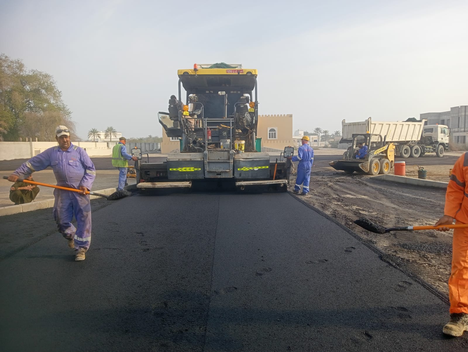 Paving crew working behind an asphalt paver