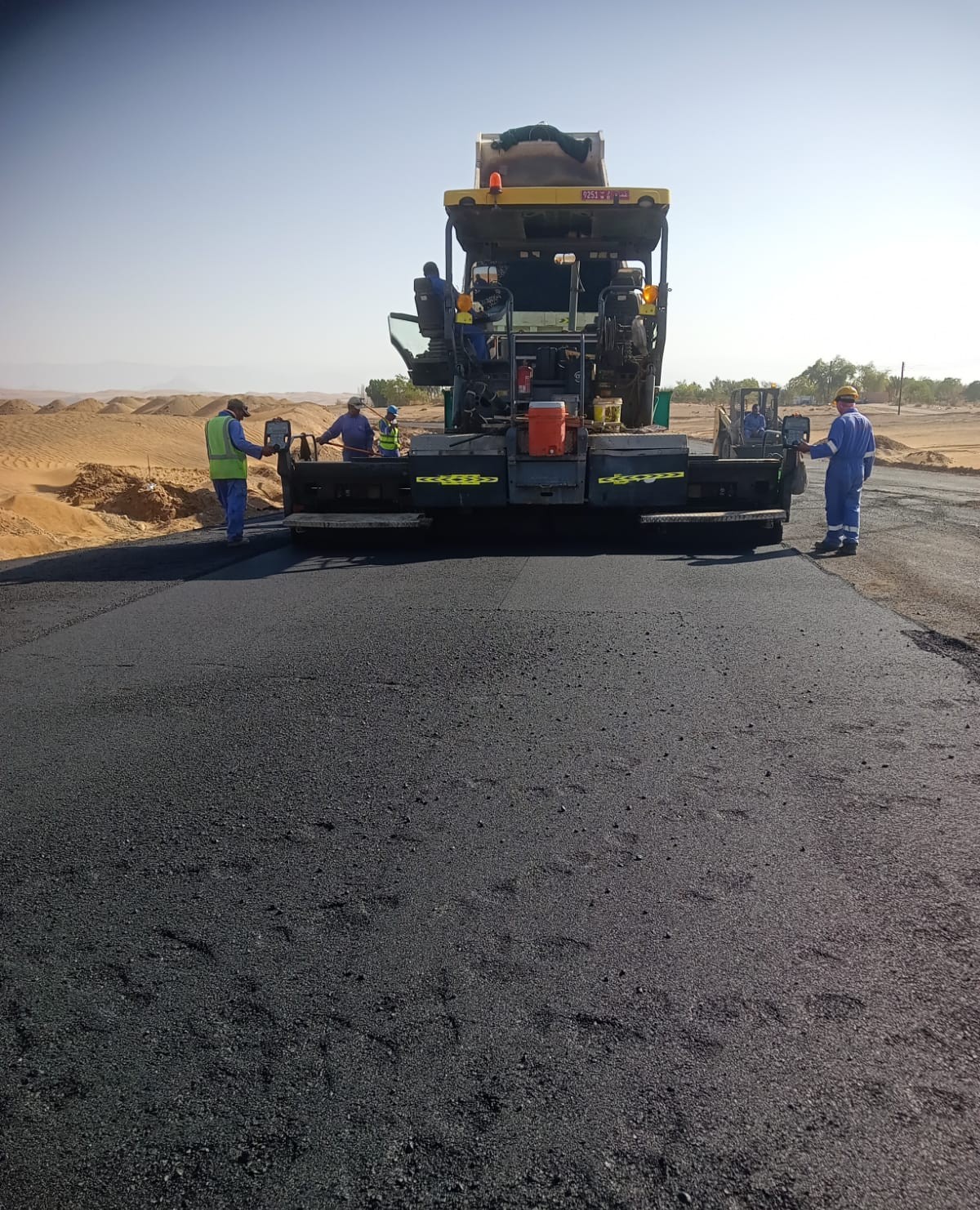 Asphalt paver laying hot mix