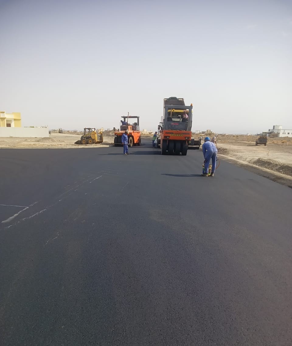 Two rollers compacting a new asphalt carriageway